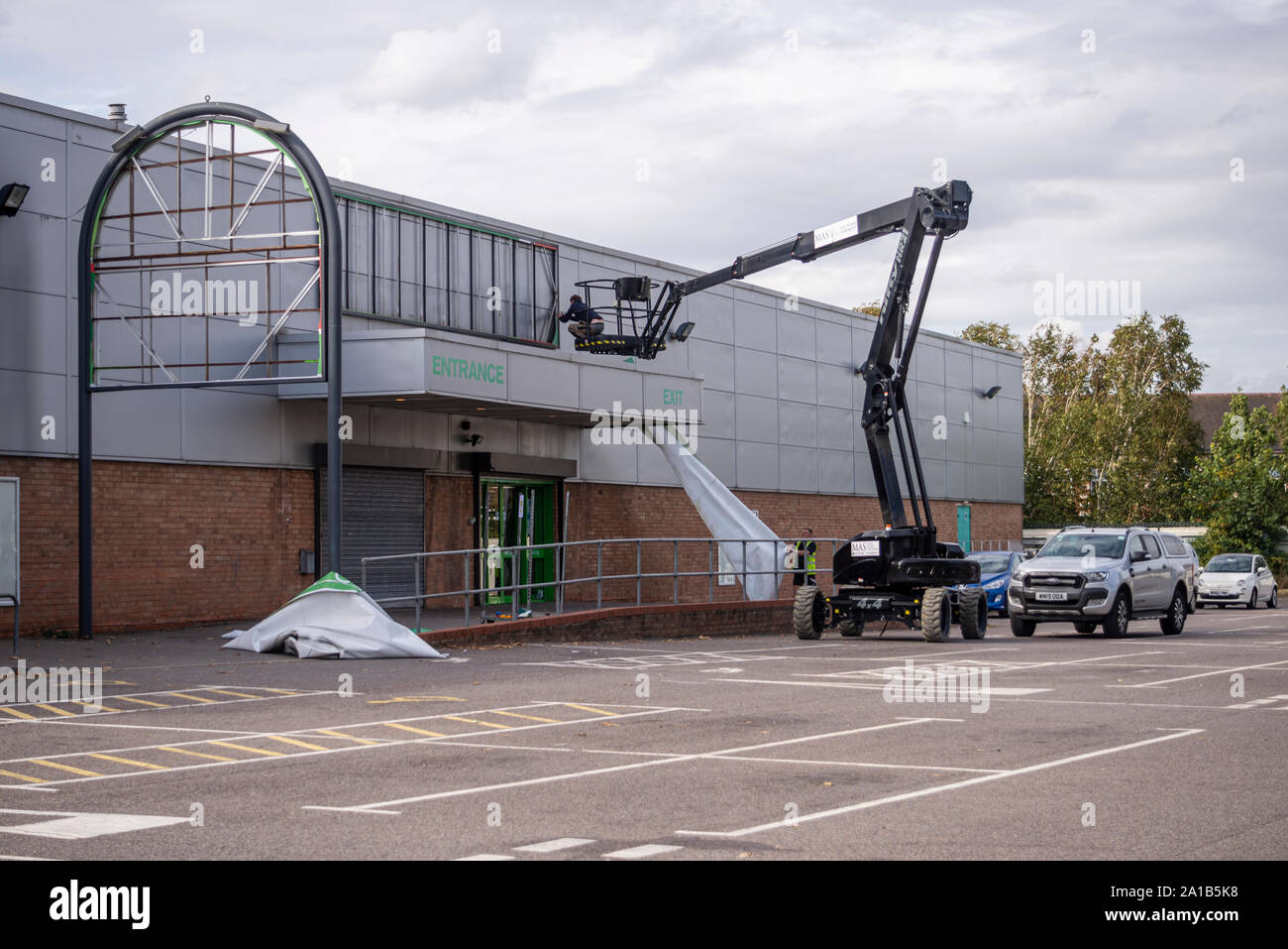 Name banner being removed from Homebase store in Southend on Sea, Essex, UK on the day of branch closure. Do it yourself warehouse closed down Stock Photo