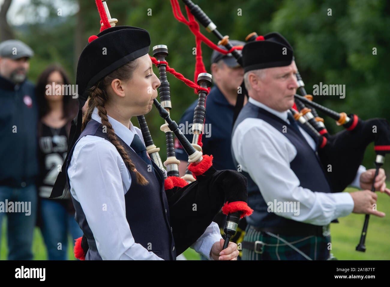 Young woman from the Camelon and District Pipe Band playing the bagpipes at the Peebles highland games. Scottish borders, Scotland Stock Photo