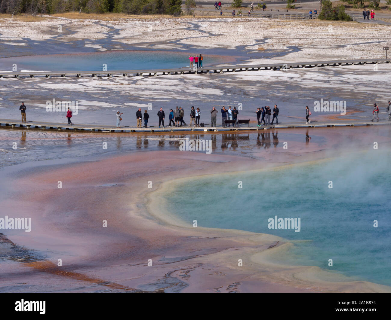 Tourists walking on boardwalk, Grand Prismatic Spring, Midway Geyser Basin, Yellowstone National Park, Wyoming, USA Stock Photo