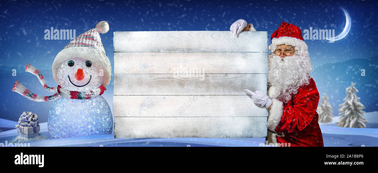 Happy santa claus pointing on blank advertisement banner with copy space. Christmas theme, sales - Image Stock Photo