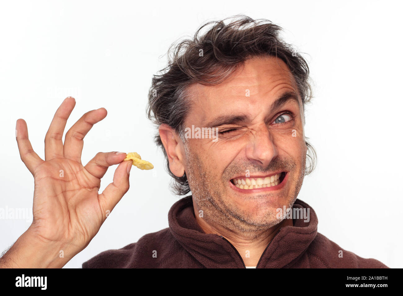 happy man eating corn appetizer over white background Stock Photo
