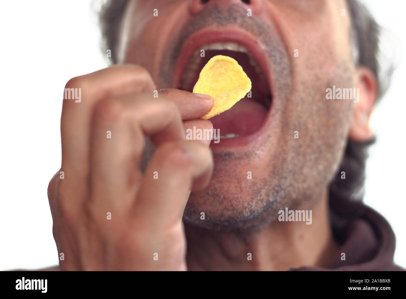 out of focus man eating crispy corn appetizer Stock Photo