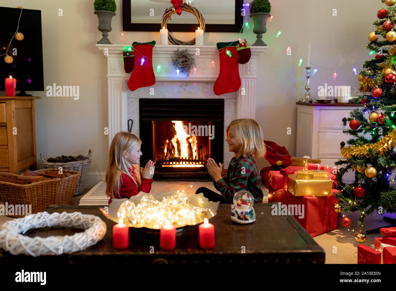 Brother and sister at home at Christmas time Stock Photo