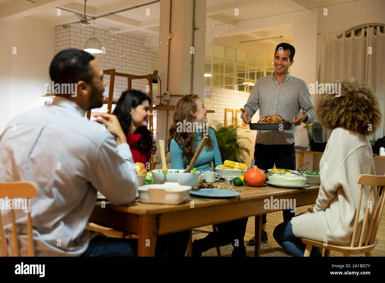 Millennial adult friends celebrating Thanksgiving together at home Stock Photo