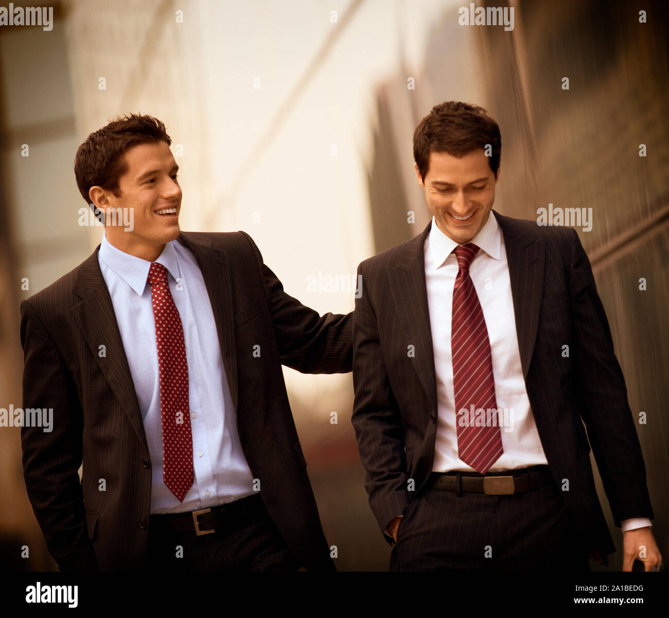 Businessmen walking and talking together Stock Photo - Alamy