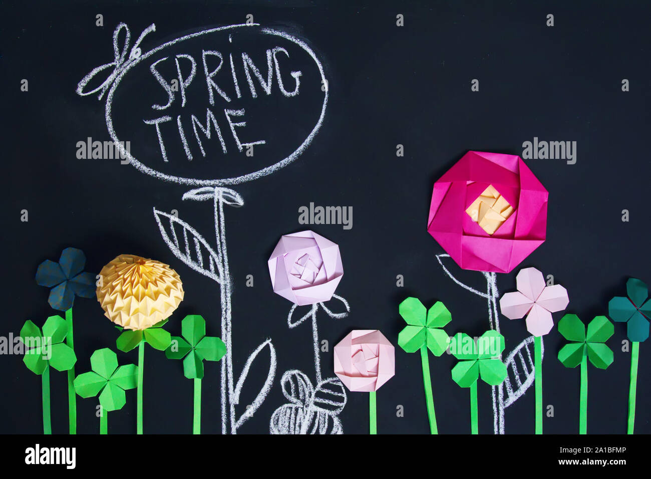 Blackboard background with painted with chalk and origami flowers Stock Photo
