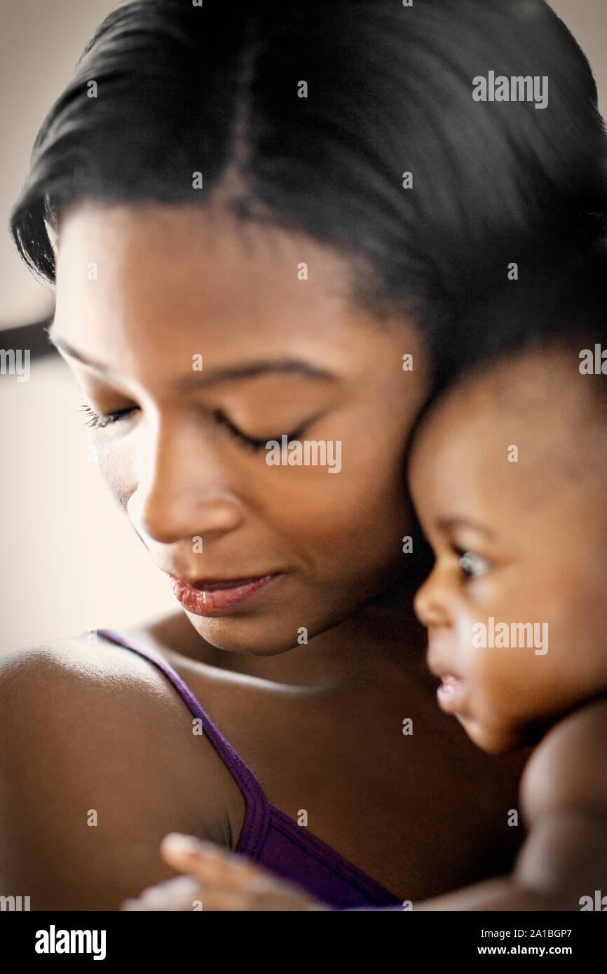Young mother holding her baby. Stock Photo