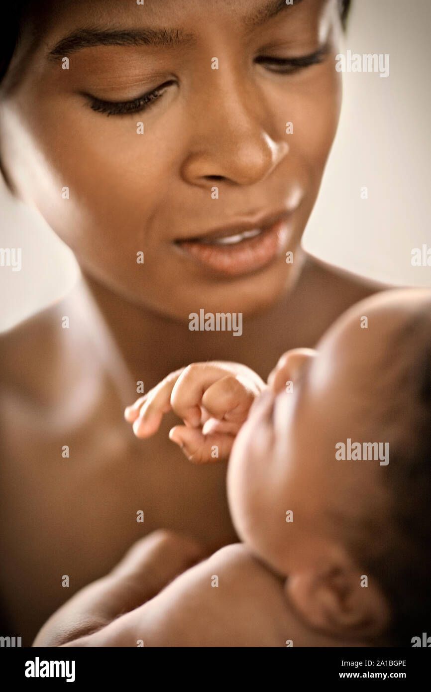 Young mother holding her baby. Stock Photo