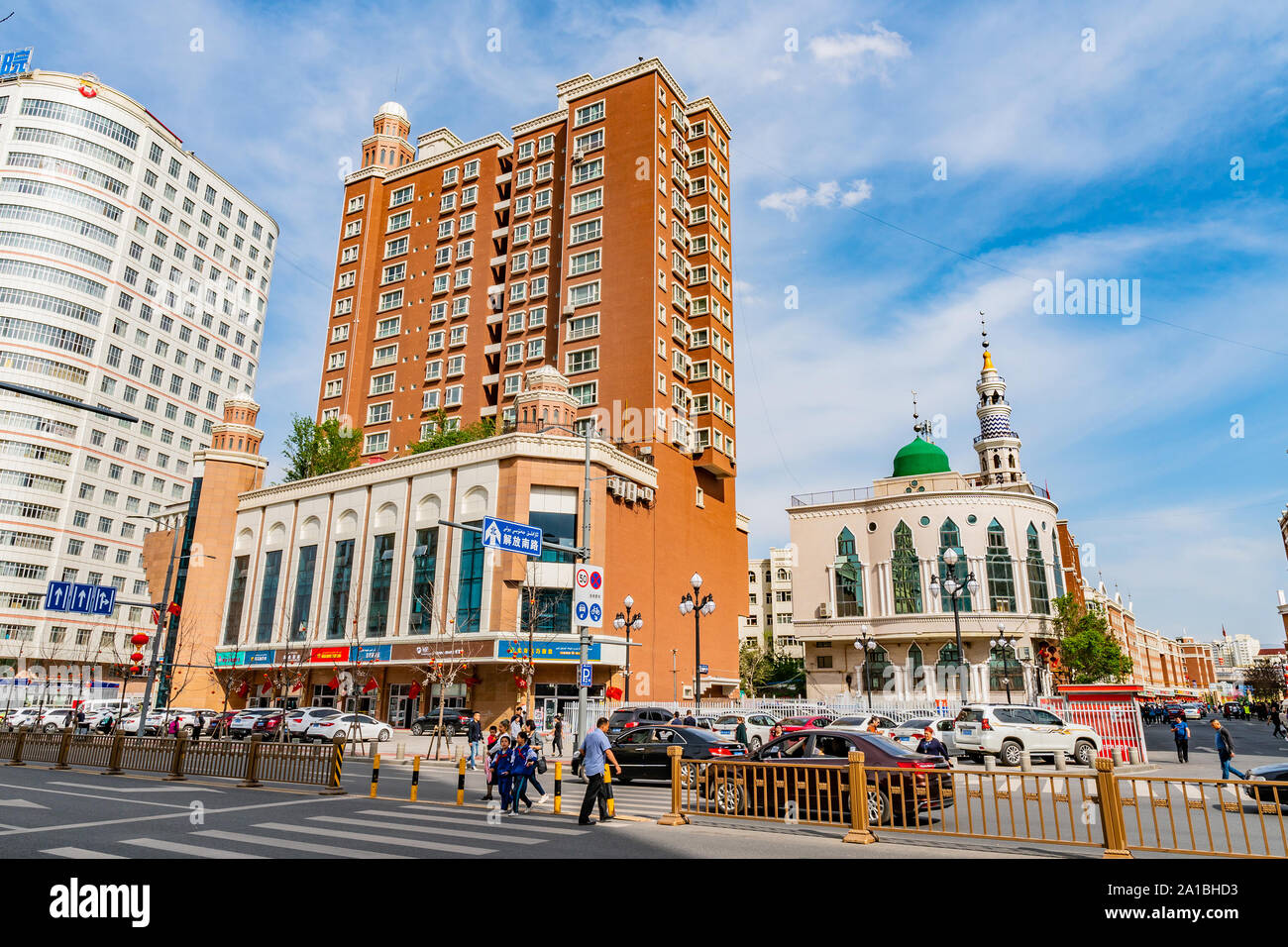 Urumqi Common Skyscrapers at a Busy Xinhua Road with Walking People on a Sunny Blue Sky Day Stock Photo