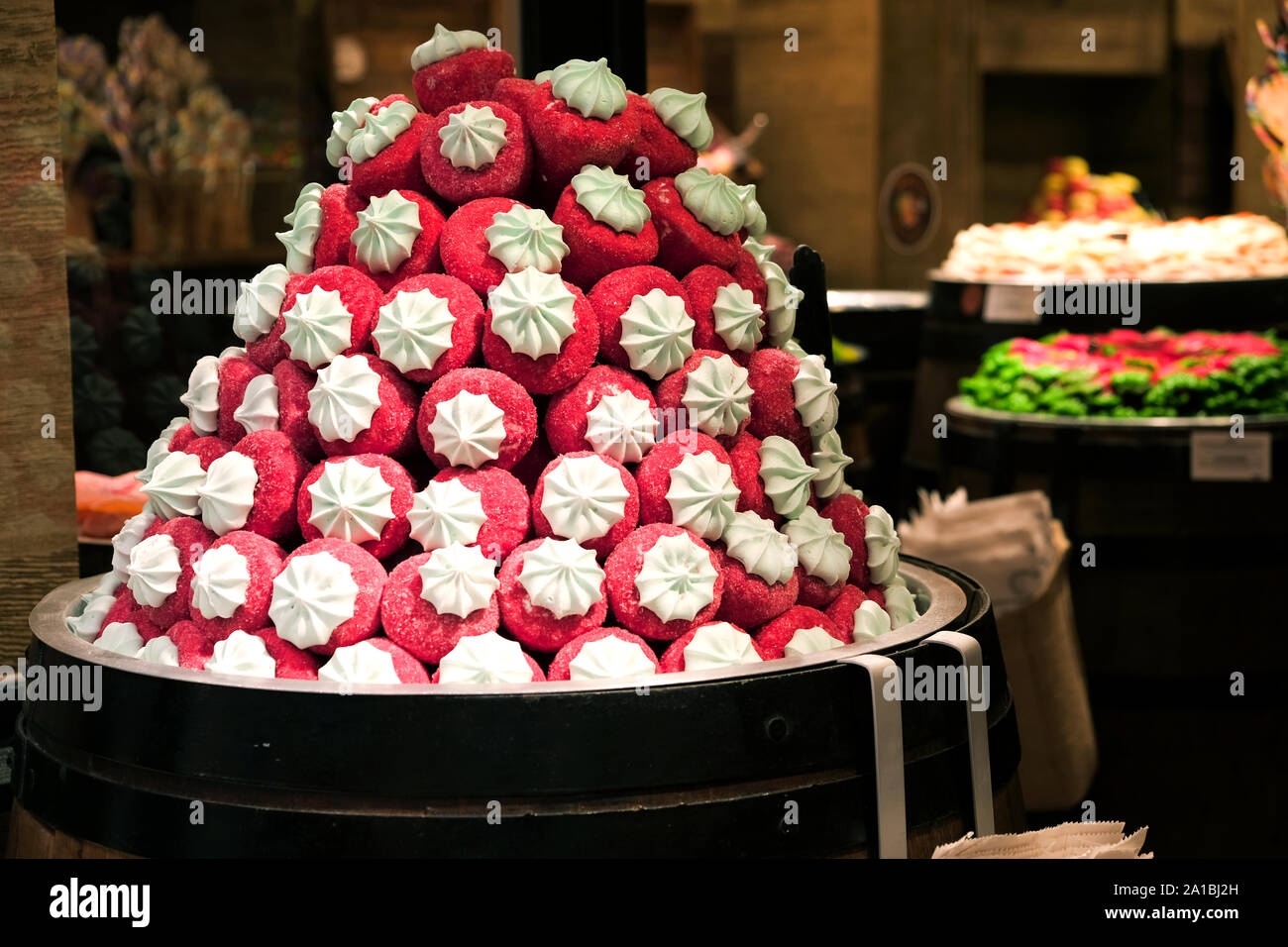A brightly coloured confectionary display in a shop located in the Old Town of Dubrovnik. The sweets are shaped and coloured as strawberries and cream Stock Photo