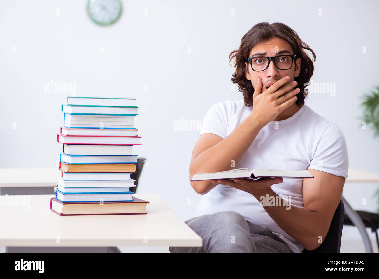 The young male student sitting in the classroom Stock Photo - Alamy