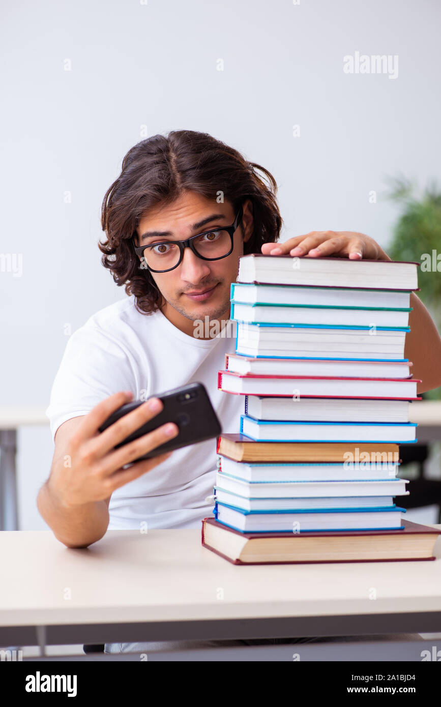 The young male student sitting in the classroom Stock Photo - Alamy