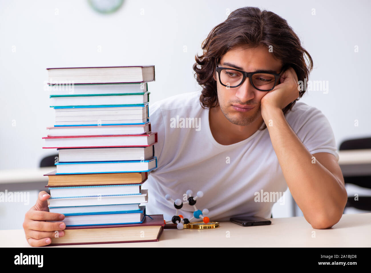 The young male student sitting in the classroom Stock Photo - Alamy
