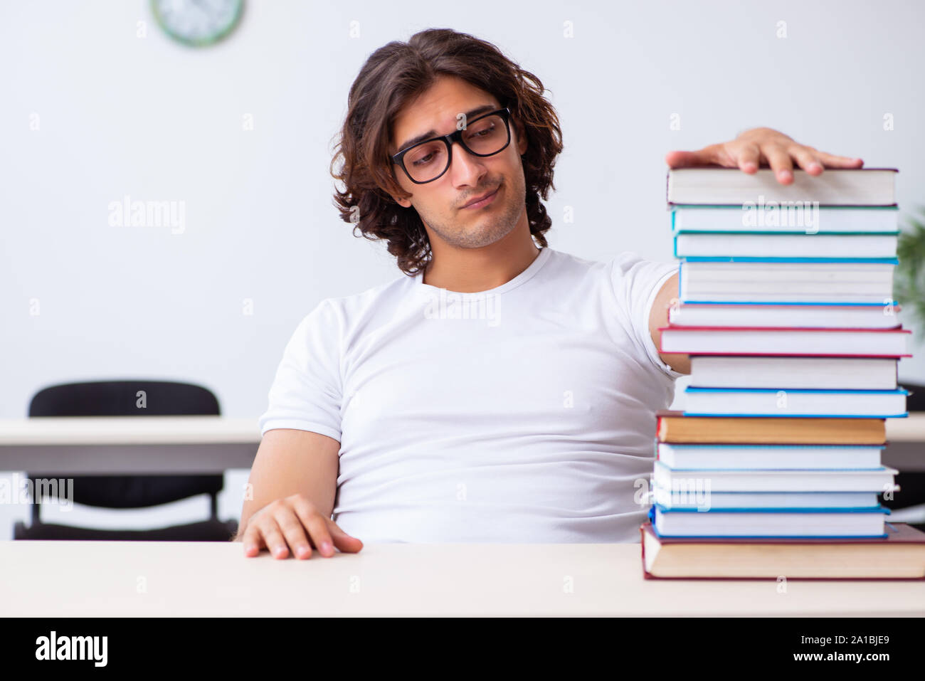 The young male student sitting in the classroom Stock Photo - Alamy
