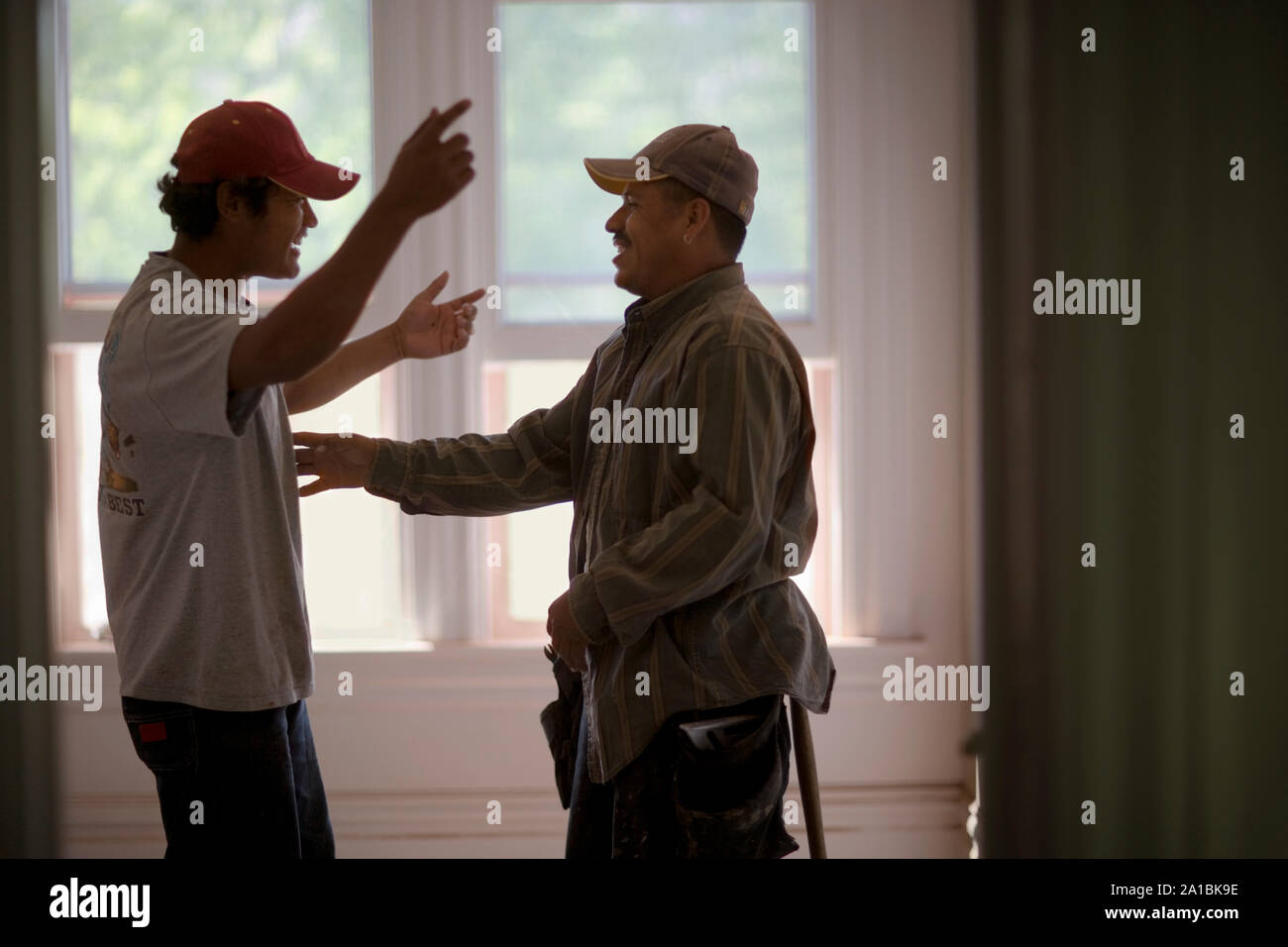 Two male builders sharing a joke. Stock Photo