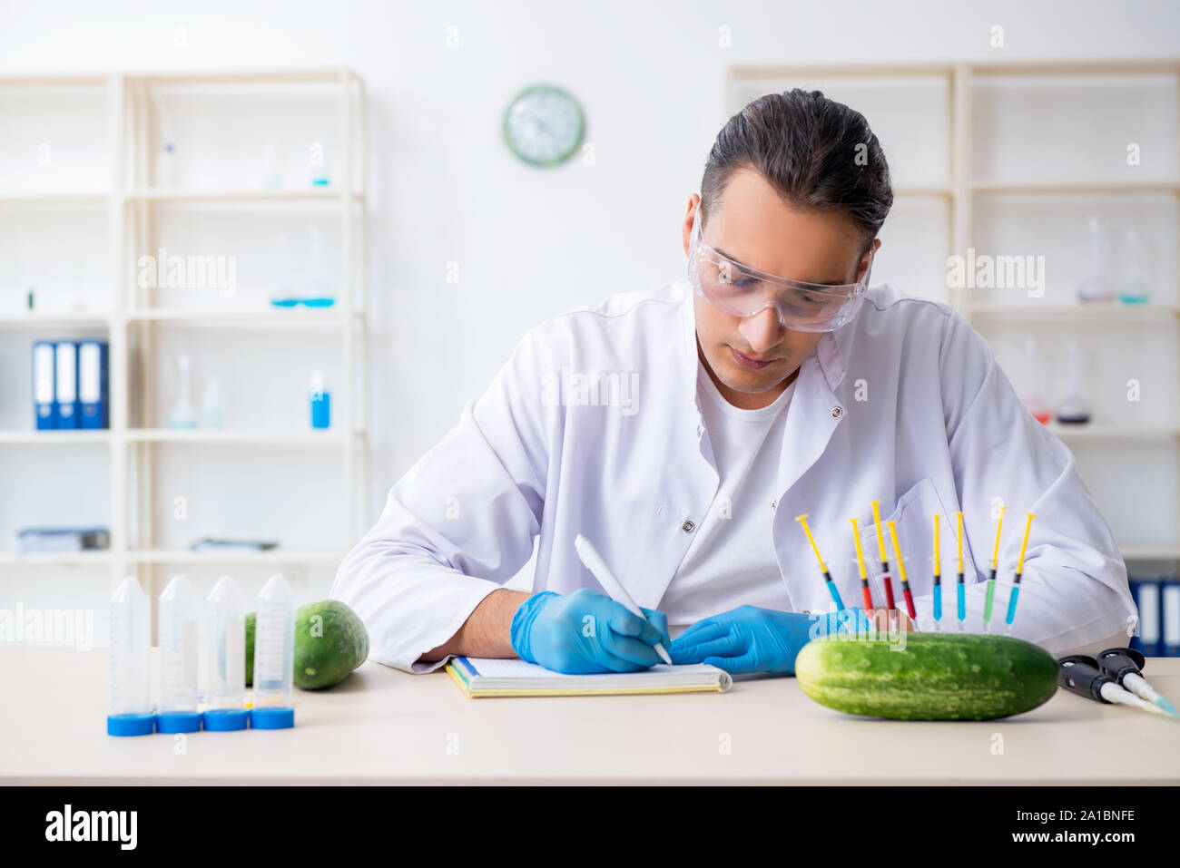 The male nutrition expert testing vegetables in lab Stock Photo Alamy