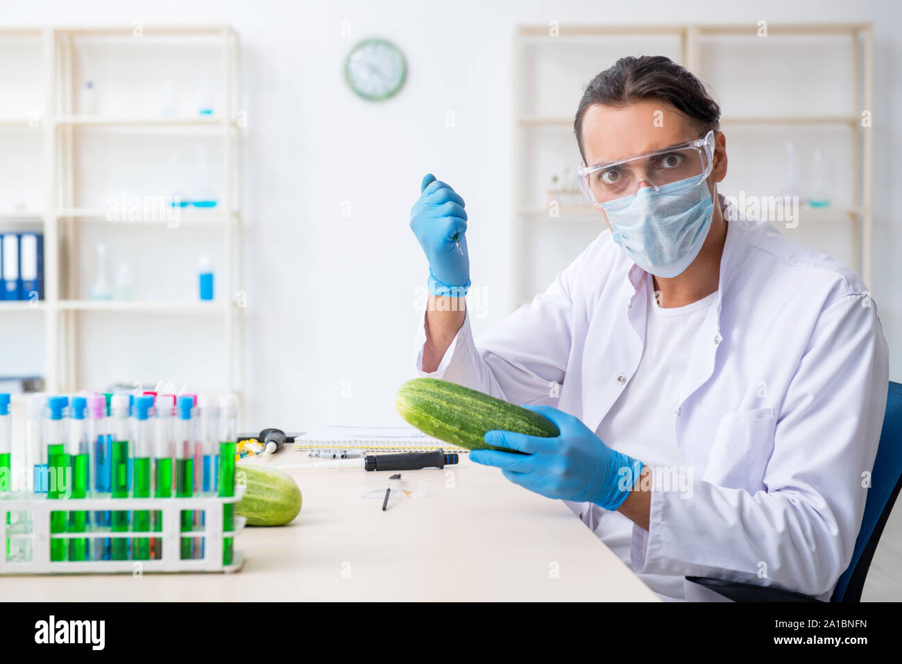 The male nutrition expert testing vegetables in lab Stock Photo - Alamy