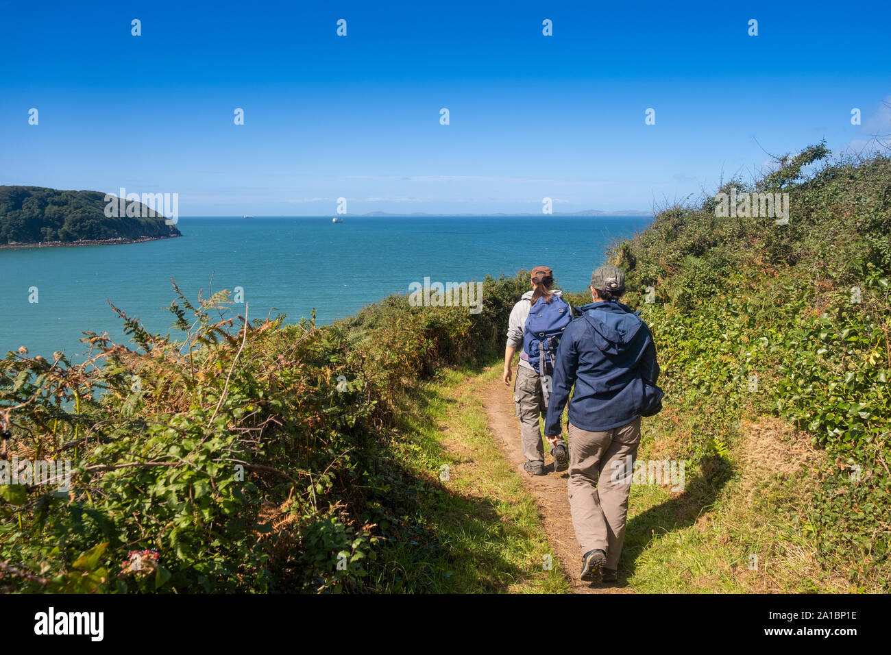 People walking on the Pembrokeshire Coastal Path near Little Haven, on the coast of St Bride's Bay, Pembrokeshire National Park, South West Wales UK Stock Photo