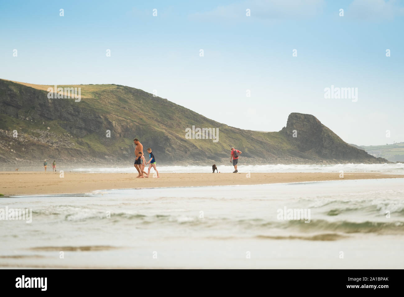 People walking on Newgale beach on the coast of St Bride's Bay, Pembrokeshire National Park, South West Wales UK Stock Photo