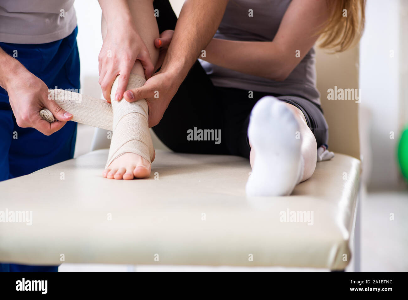 The leg injured woman visiting young doctor traumatologist Stock Photo ...