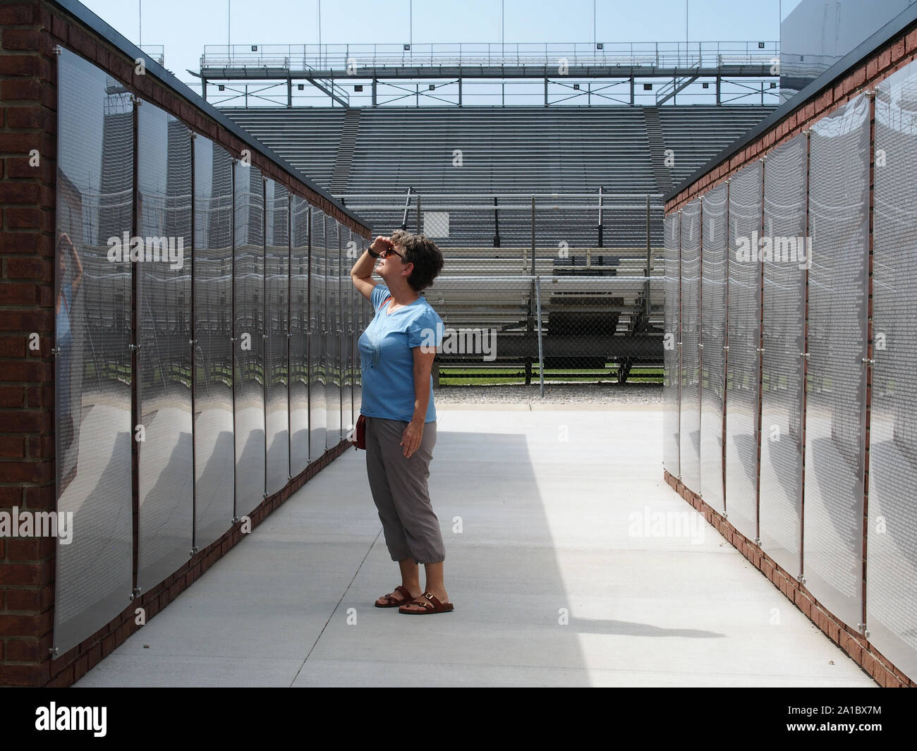 Woman looking at names listed on  the Crown Royal Wall of Gratitude at the Indianapolis Motor Speedway, Indiana, July 28, 2019, © Katharine Andriotis Stock Photo