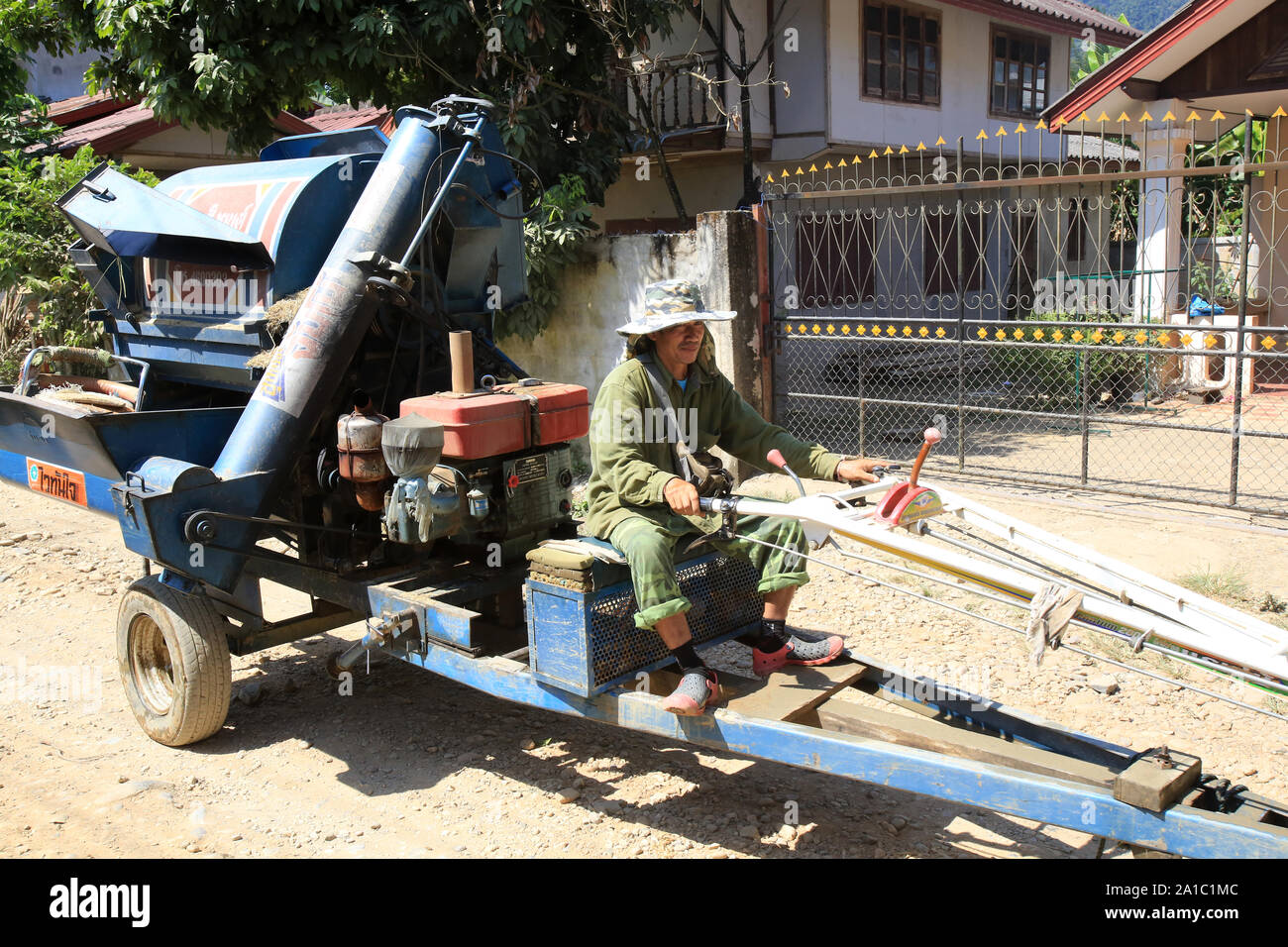 Fermier sur son tracteur. Vieng Vang. Laos. / Tractor downtown. Vang Vieng. Laos. Stock Photo