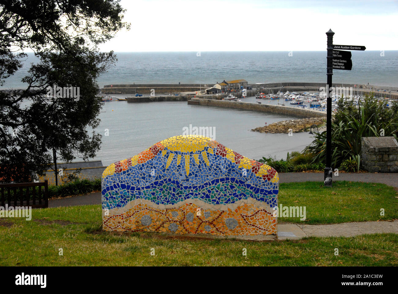Colouful ceramic seat on hill overlooking Lyme Regis bay, Dorset, England, on an overcast day Stock Photo