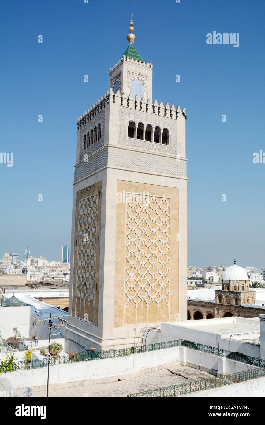 The square minaret of the Zeitoun mosque towers over rooftops of the Tunis old city and medina, Tunisia. Stock Photo