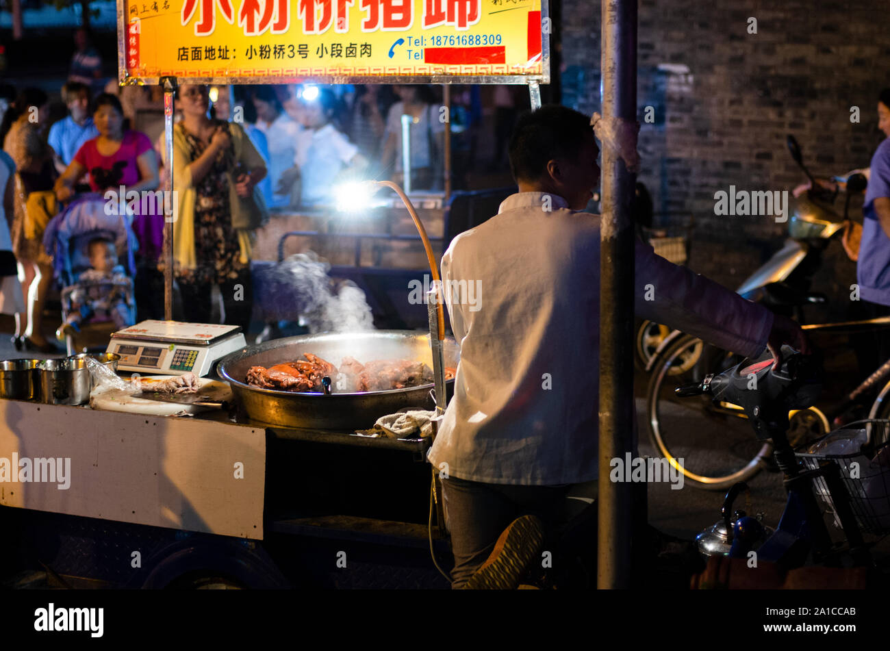 Street food stall outside Guangzhou Lu metro station in Nanjing Stock Photo