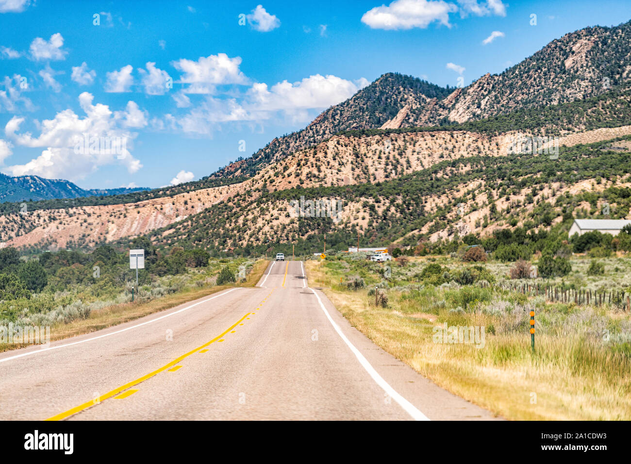 Canyon mountains near Rifle, Colorado with cars on road during sunny