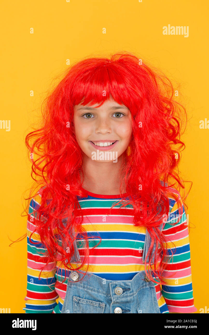 Crazy redhead wig. Messy hairstyle. Kid cheerful smiling happy redhead girl. I am ginger and proud of it. Redhead stereotypes. Redheads are not some creatures with magical soul sucking powers. Stock Photo