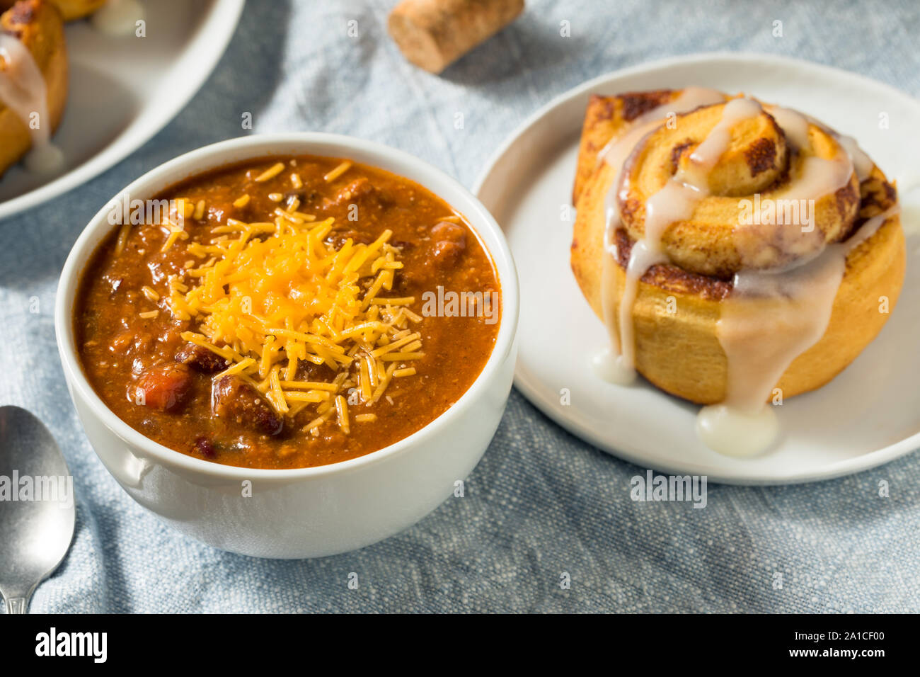 Homemade Chili Soup and Cinnamon Roll for Lunch Stock Photo
