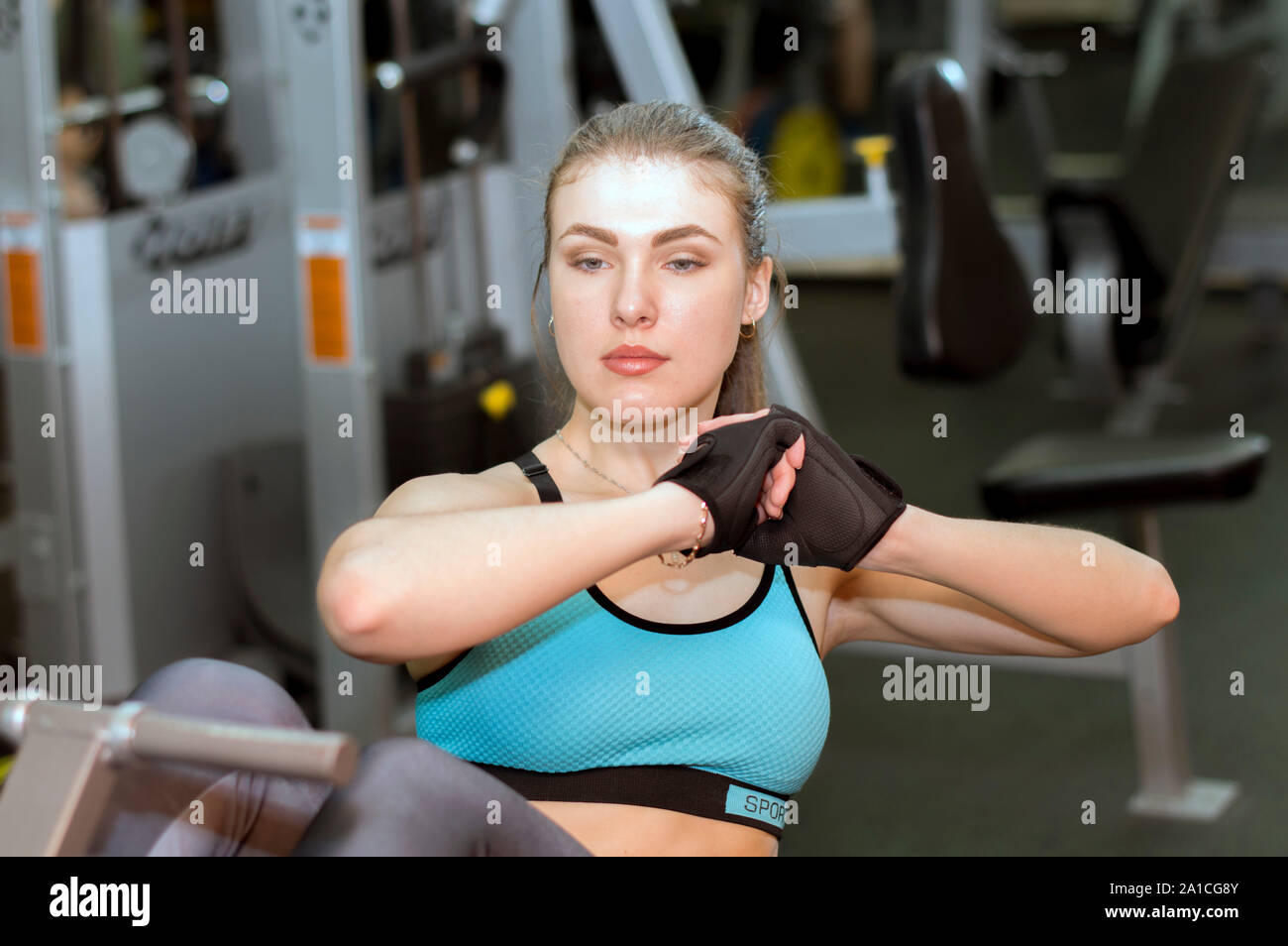 Woman at gymnastic physical training fitness exercise in gym. Stock Photo