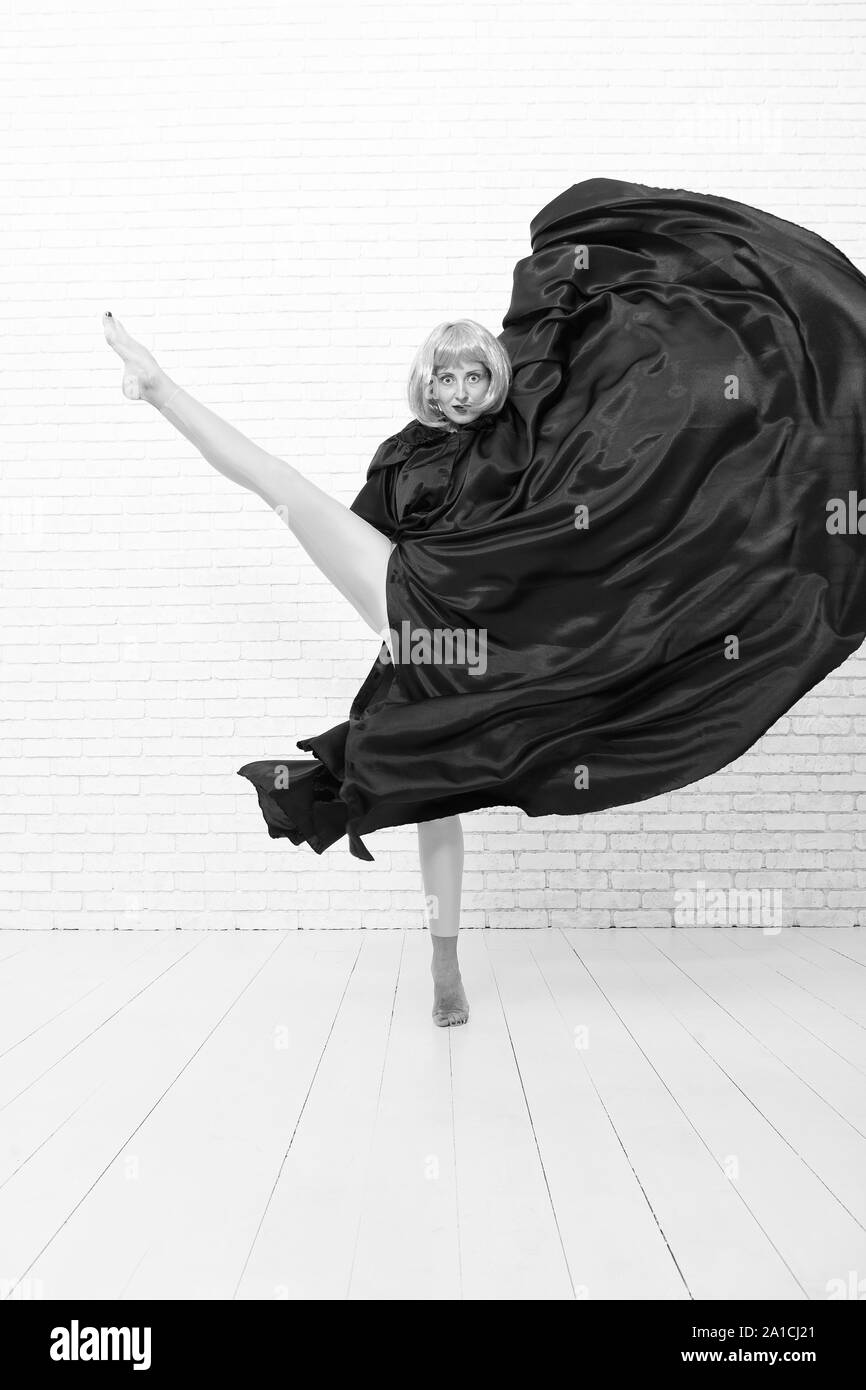 Little Girl in Black Tights Dancing on a Gray Background. Stock