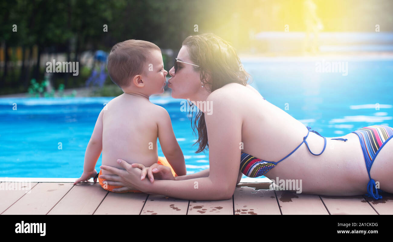 Banner Close Up Of Mother And Son By The Pool During Summer