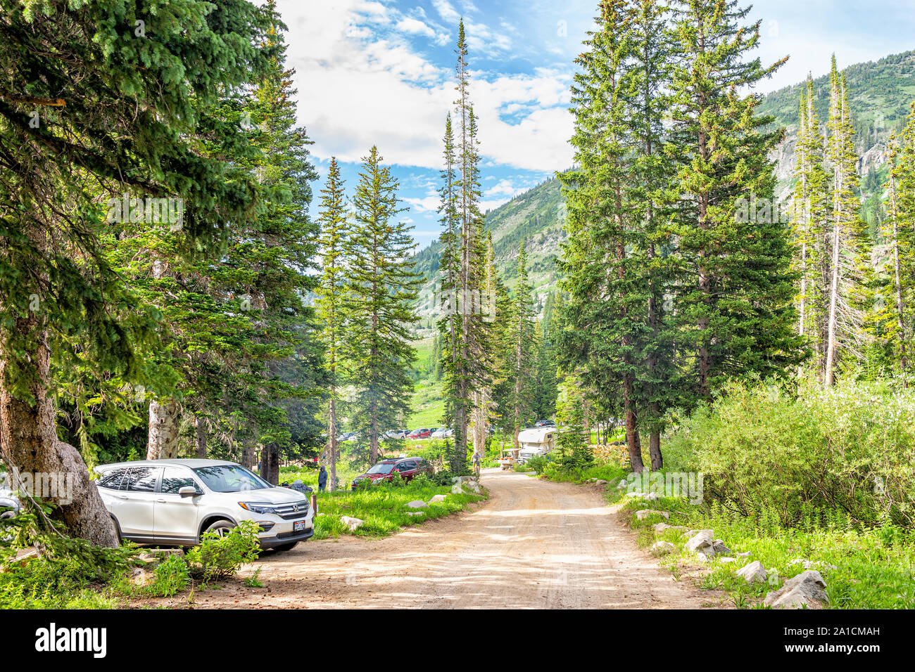 Alta, USA - July 25, 2019: Campsites with cars and dirt road in Albion Basin, Utah summer in Wasatch mountains with nobody Stock Photo
