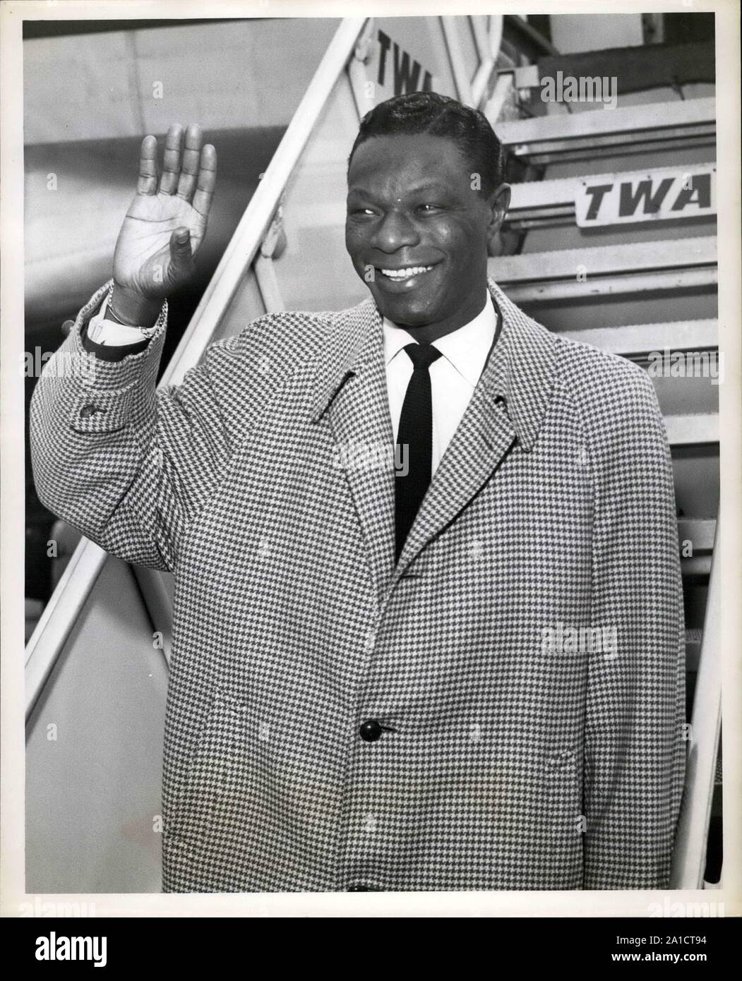 May 1957 - New York, New York, USA - Singer NAT KING COLE arrives at Idlewild Airport this morning on a TWA Ambassador flight from Los Angeles. Cole is in town for the  premiere of ''China Gate,'' the movie in which he makes his acting debut. (Credit Image: © Keystone Pictures USA/ZUMAPRESS.com) Stock Photo