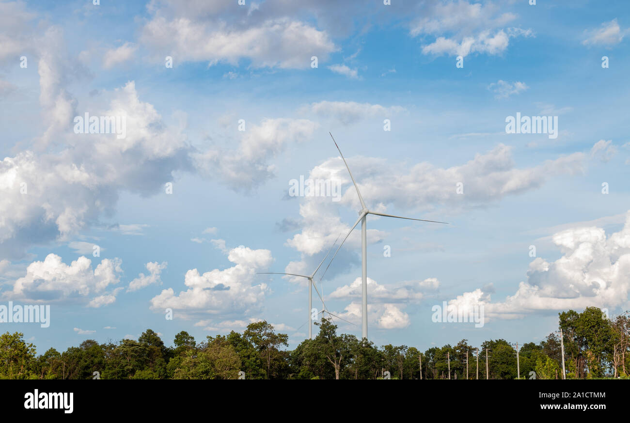 Wind turbine farm power generator in beautiful nature landscape for production of renewable green energy is friendly industry to environment. Stock Photo