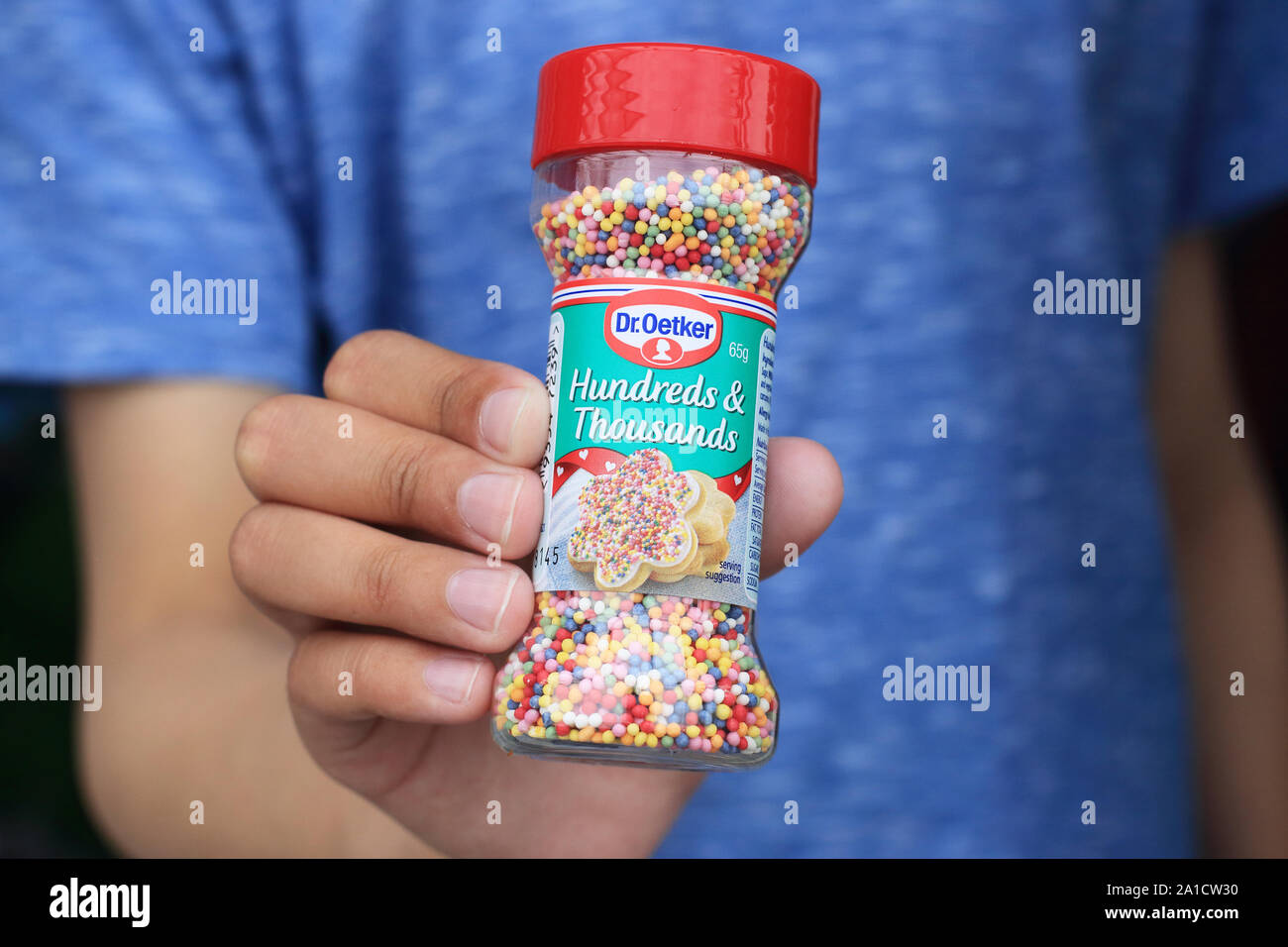 Hand holding Dr. Oetker Hundreds and Thousands edible colourful sprinkles Stock Photo
