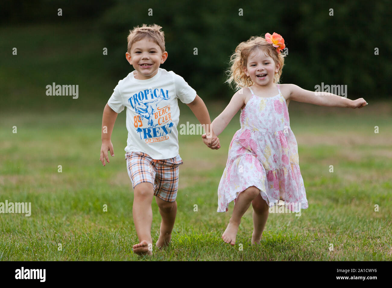 Little caucasian boy and little caucasian girl are holding hands and ...