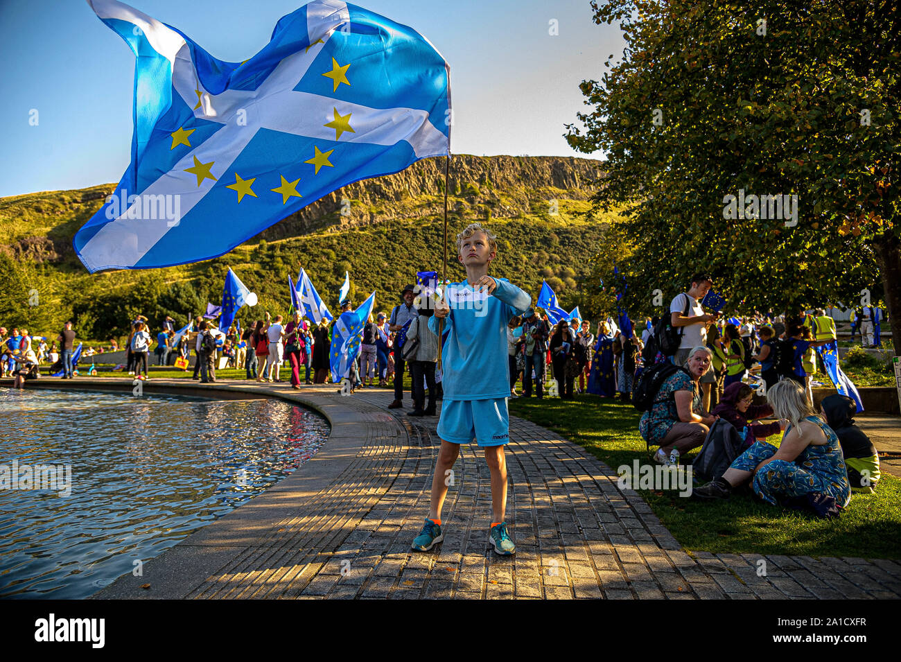 A boy waving a Scotland in EU flag during the protest outside Scottish Parliament.Organized by European Movement in Scotland as well as Edinburgh For Europe, protesters took to the streets of Edinburgh to demand MPs revoke Article 50 to prevent a no-deal and that the EU shares a notion to combat climate change. Stock Photo
