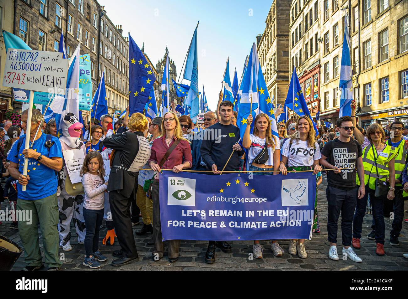 Protesters stand behind a banner with flags during the demonstration.Organized by European Movement in Scotland as well as Edinburgh For Europe, protesters took to the streets of Edinburgh to demand MPs revoke Article 50 to prevent a no-deal and that the EU shares a notion to combat climate change. Stock Photo