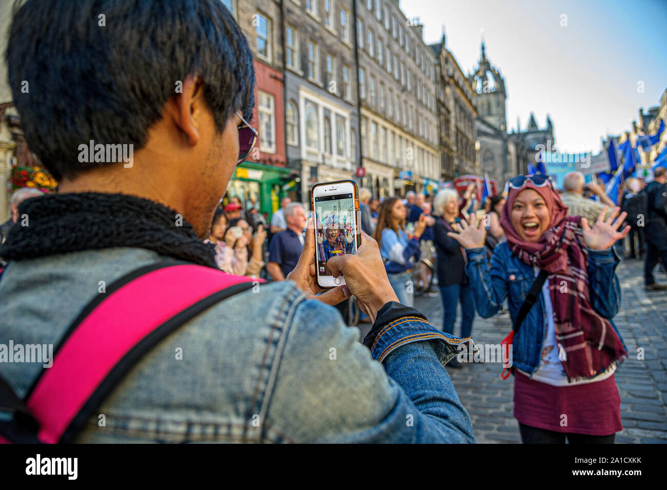 Bystanders are seen taking photos of the protesters on their phones during the demonstration.Organized by European Movement in Scotland as well as Edinburgh For Europe, protesters took to the streets of Edinburgh to demand MPs revoke Article 50 to prevent a no-deal and that the EU shares a notion to combat climate change. Stock Photo