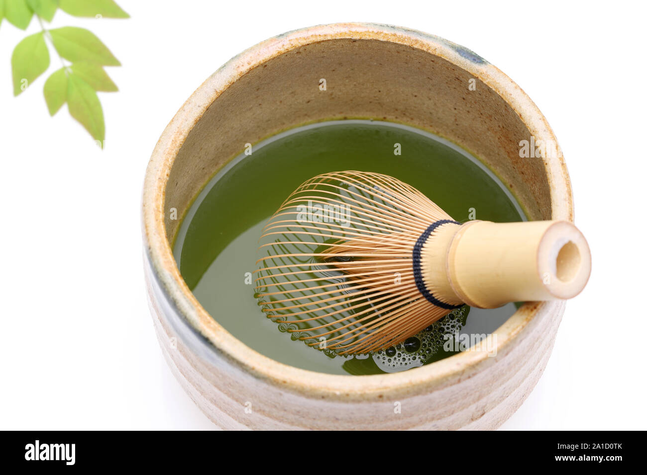 Japanese matcha green tea in a ceramic bowl with tea whisk Stock Photo