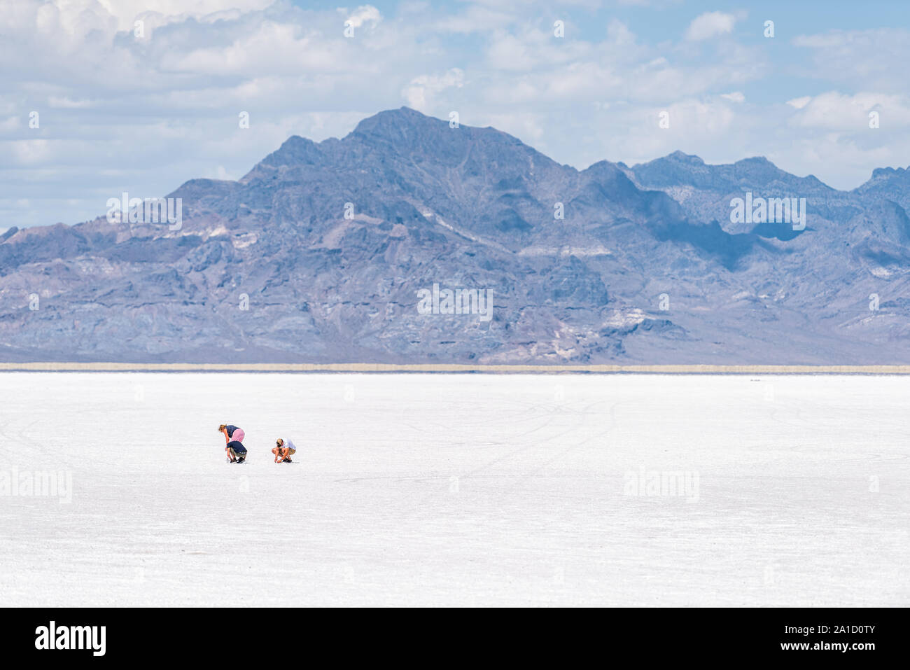 Wendover, USA - July 27, 2019: White Bonneville Salt Flats near Salt Lake City, Utah during day with people touching salt Stock Photo