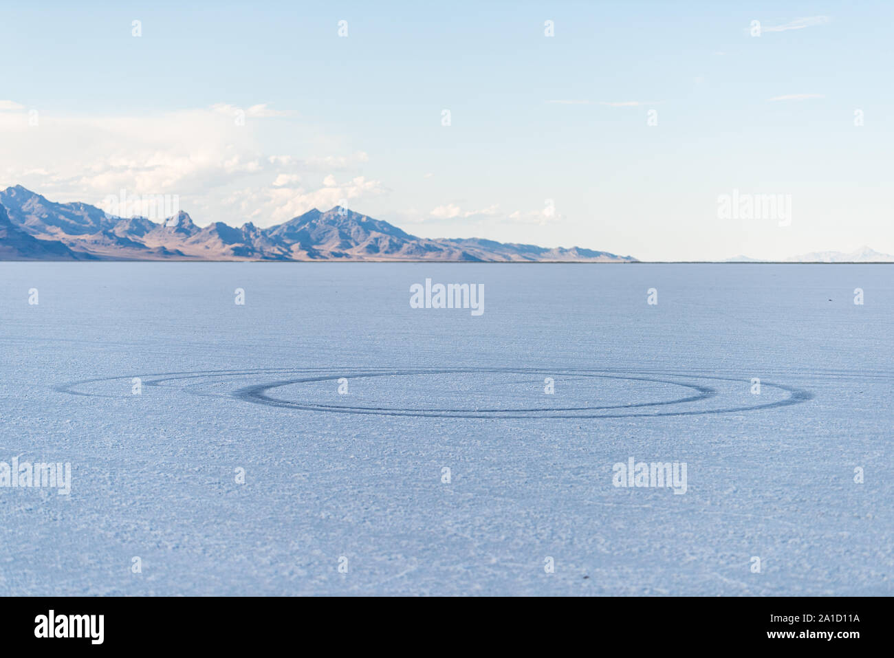 View of car tire marks tracks on White Bonneville Salt Flats near Salt Lake City, Utah during sunset Stock Photo