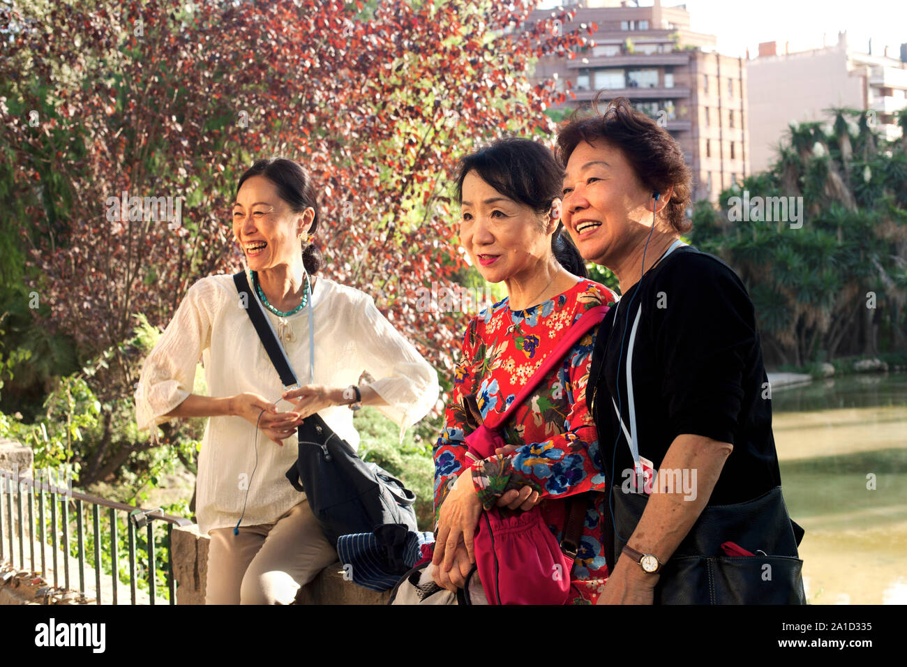 Three middle-aged Asian women pose for photos in front of the Sagrada Familia, Barcelona. Stock Photo