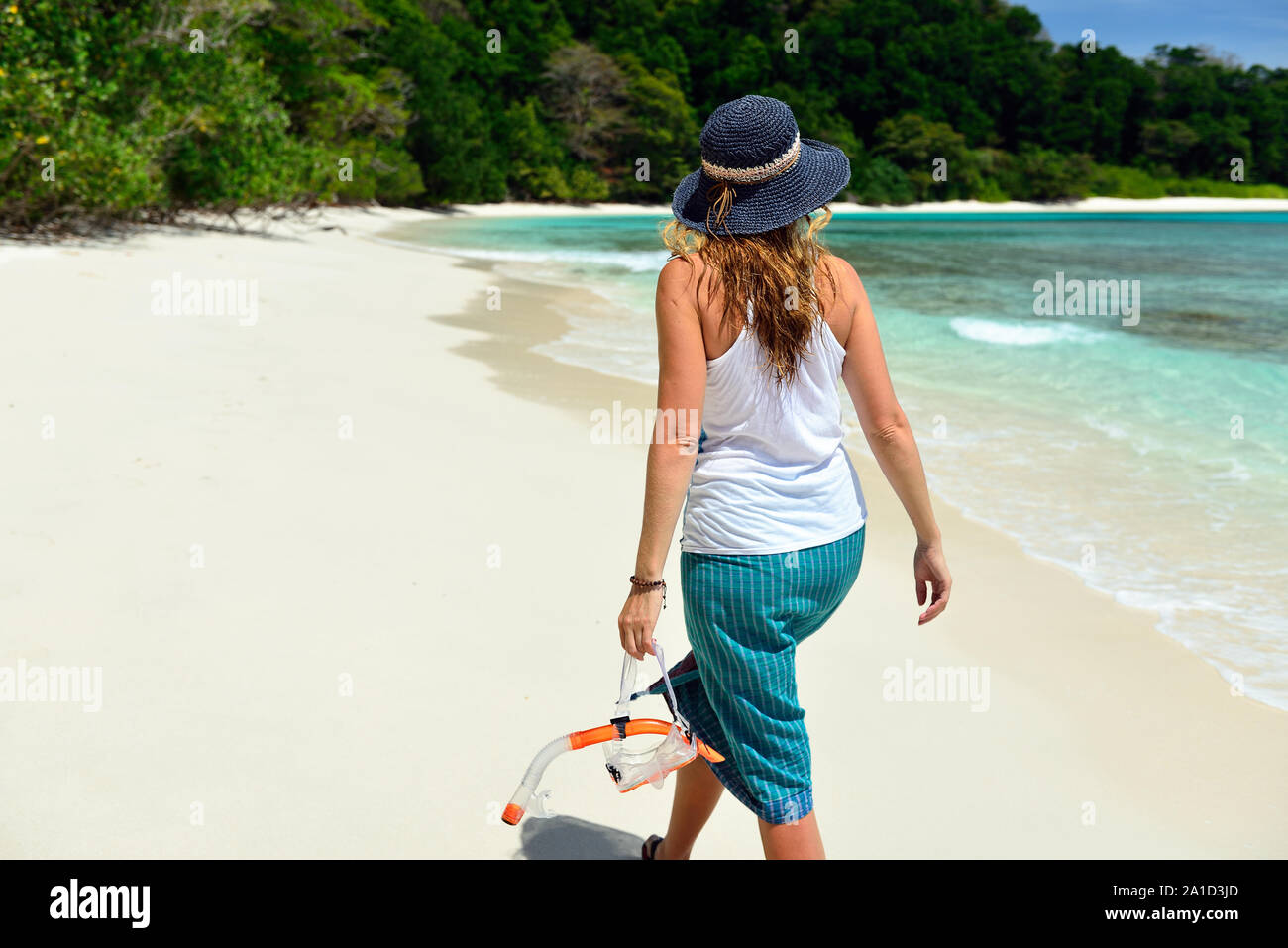 Tourist with diving equipment on the beach nr 7 at Havelock Island ...