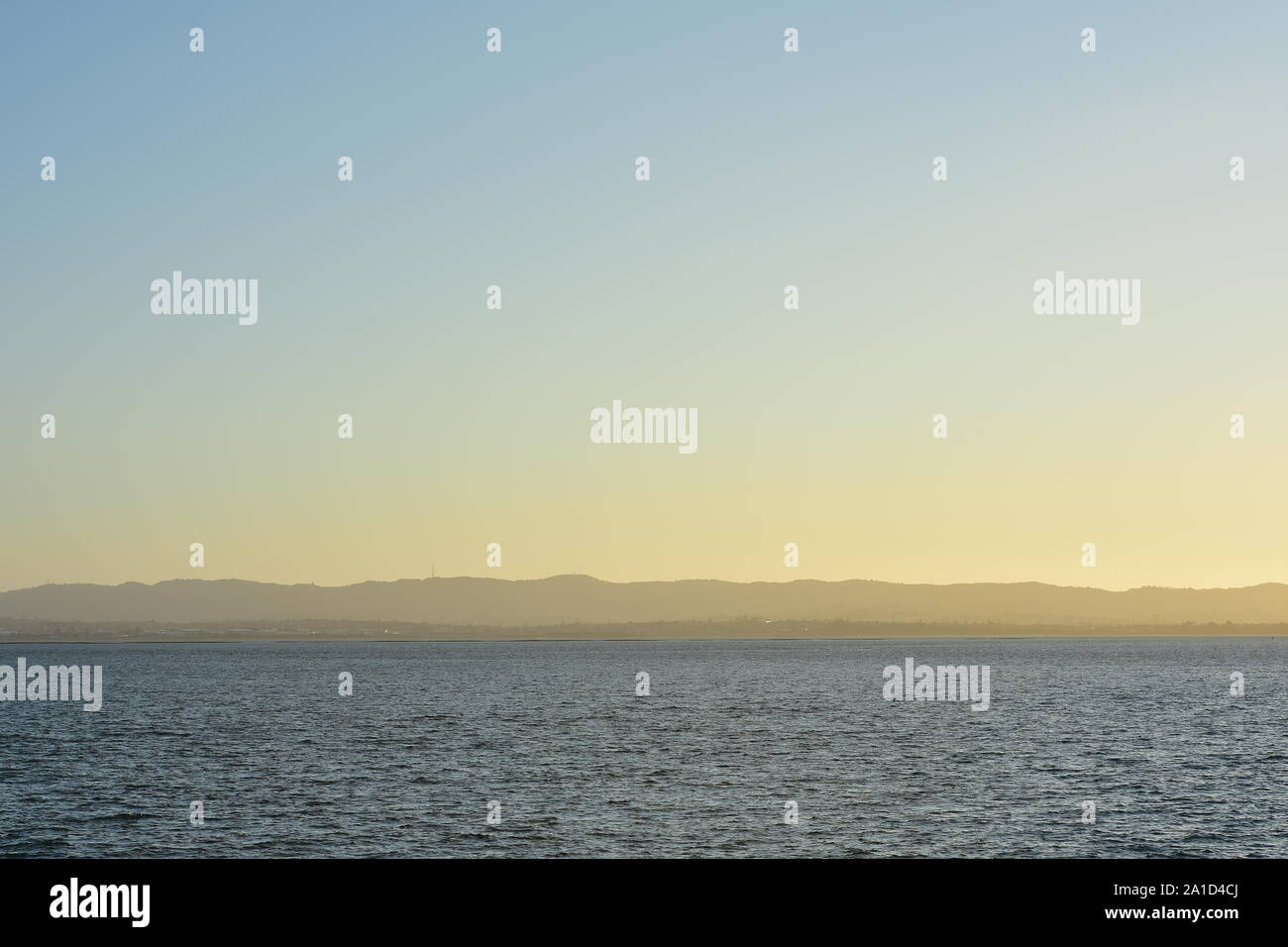 Cold morning in large harbor with distant landscape in background. Stock Photo