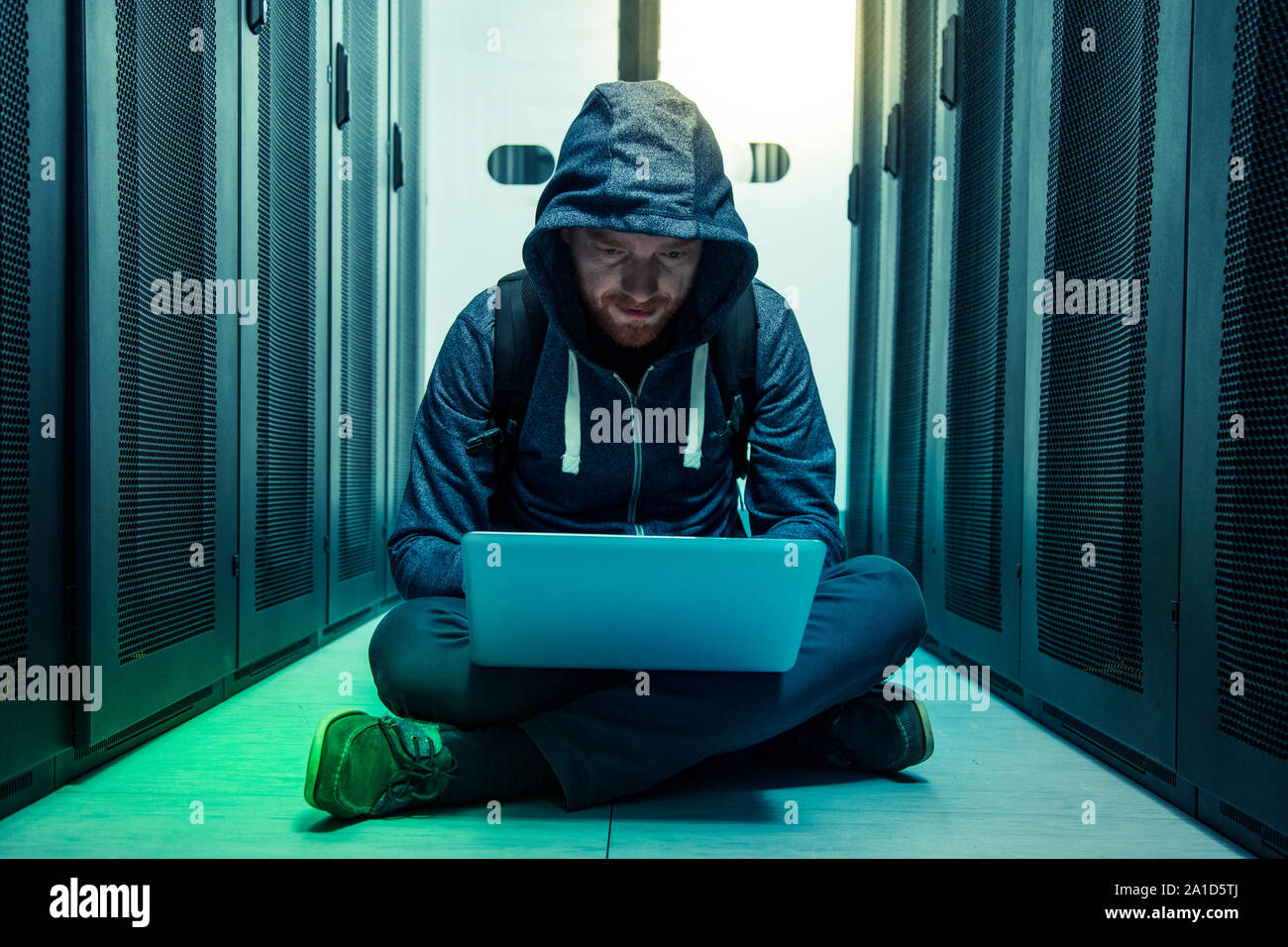 Serious intelligent man sitting on the floor Stock Photo